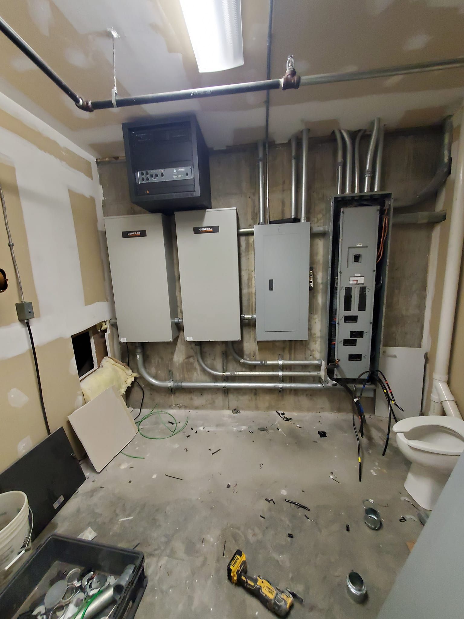 Woman in straw hat smiles, holding wine glass near a lake.