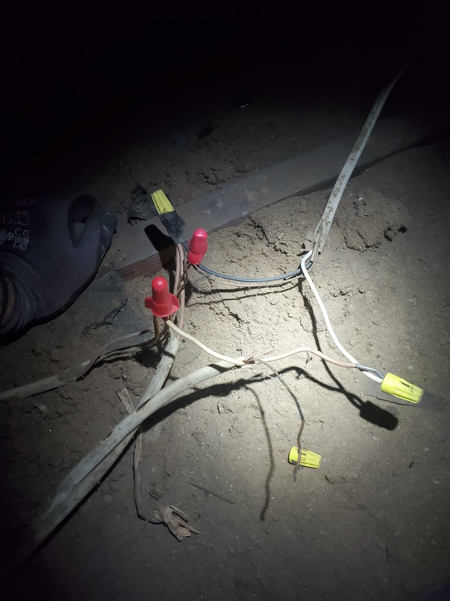Woman in straw hat smiles, holding wine glass near a lake.