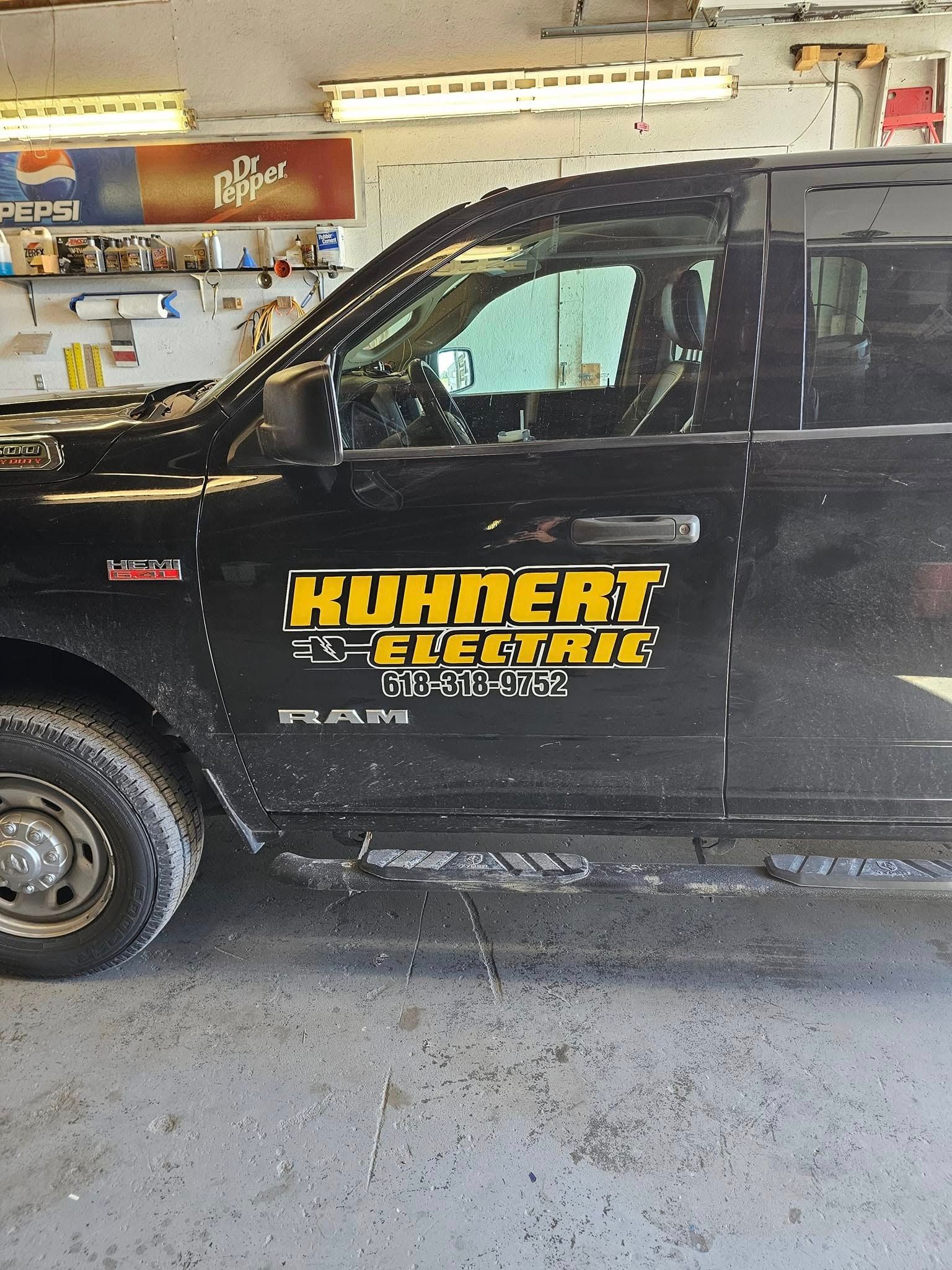 Woman in straw hat smiles, holding wine glass near a lake.