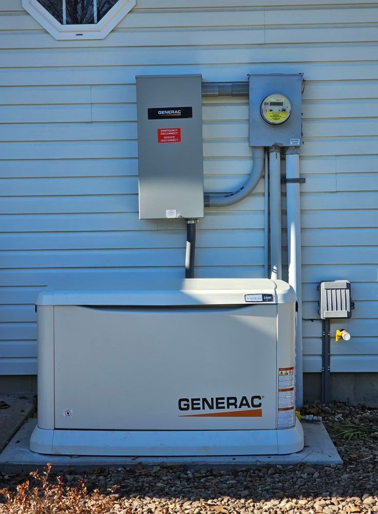 Woman in straw hat smiles, holding wine glass near a lake.
