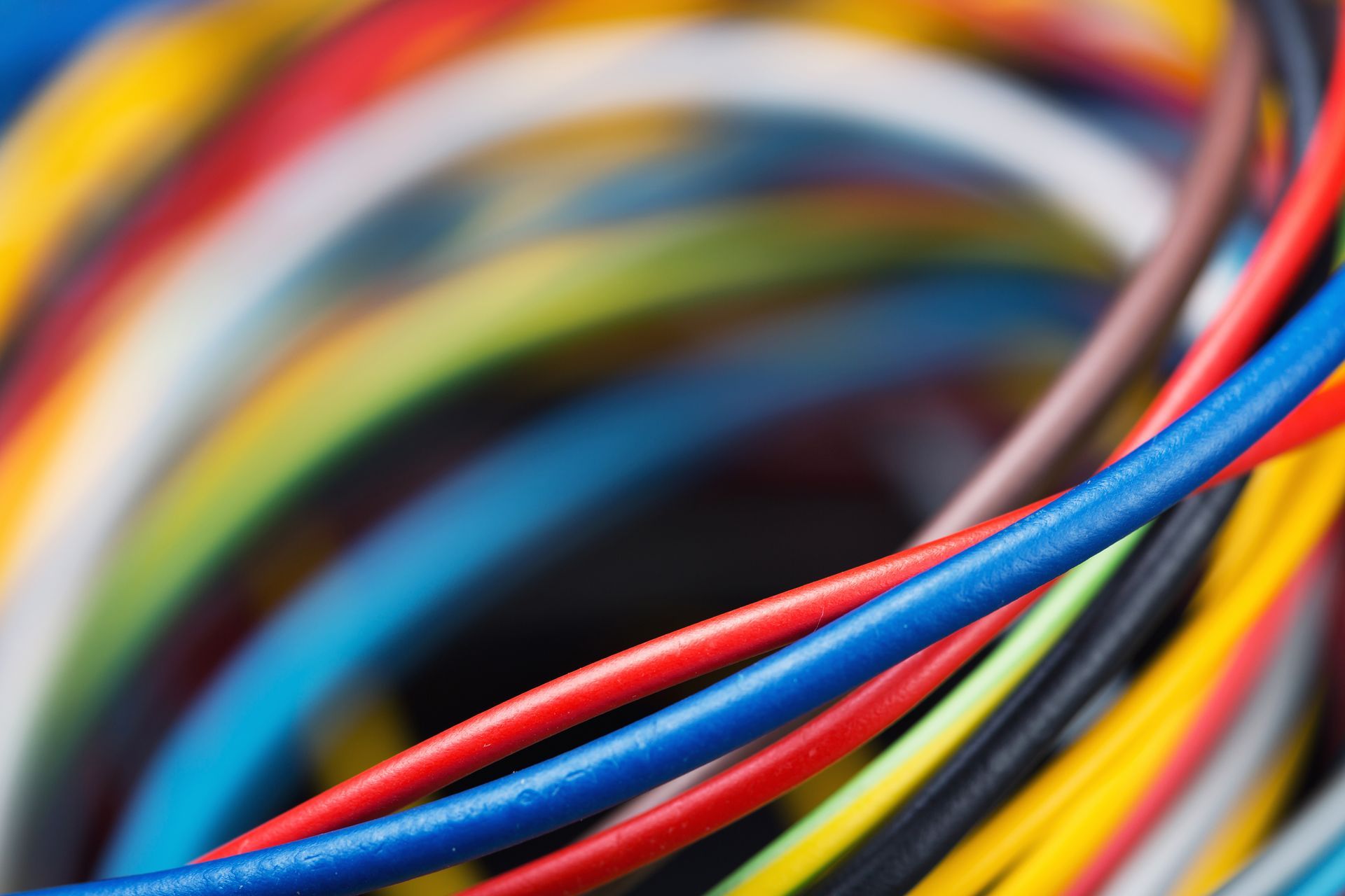 A close up of a bunch of colorful wires in a swirl.