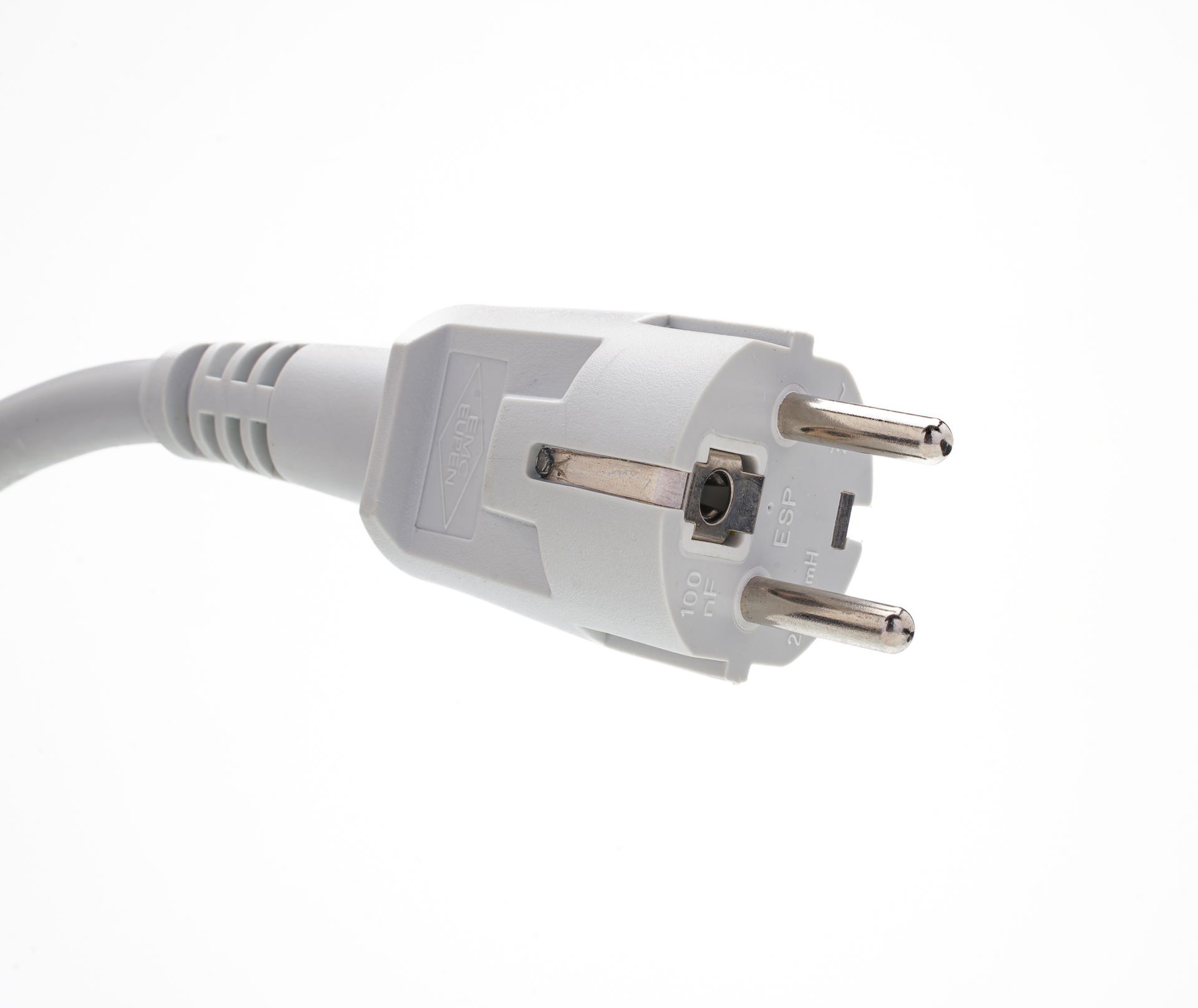 A close up of a white electrical plug on a white background.
