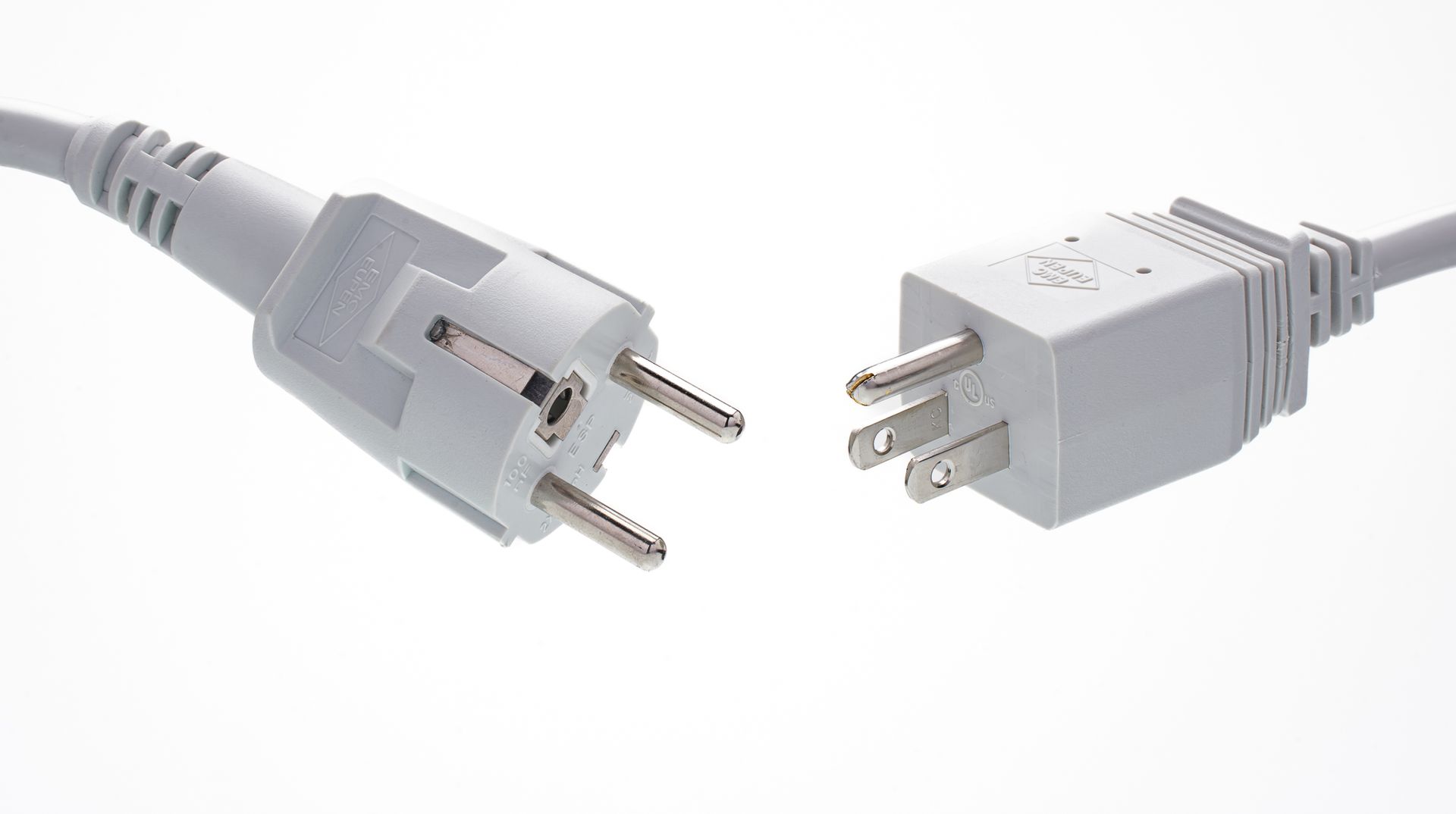 Two white plugs are connected to each other on a white background.