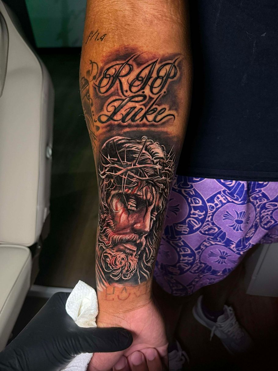 Tattoo of Jesus wearing a crown of thorns, with 