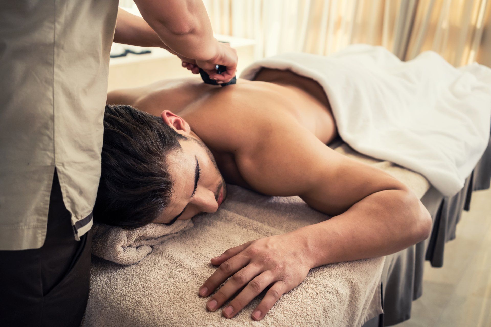 A man is getting a massage at a spa.