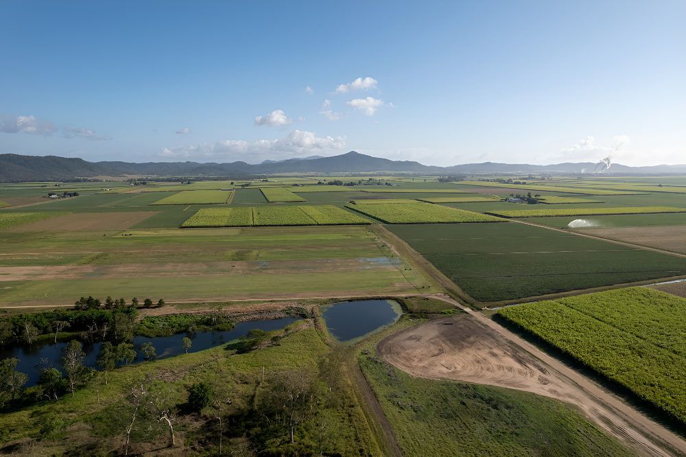An Aerial View Of A Lush Green Field With Mountains — Ollies Towing & Shipping Container Sales in Durong, QLD