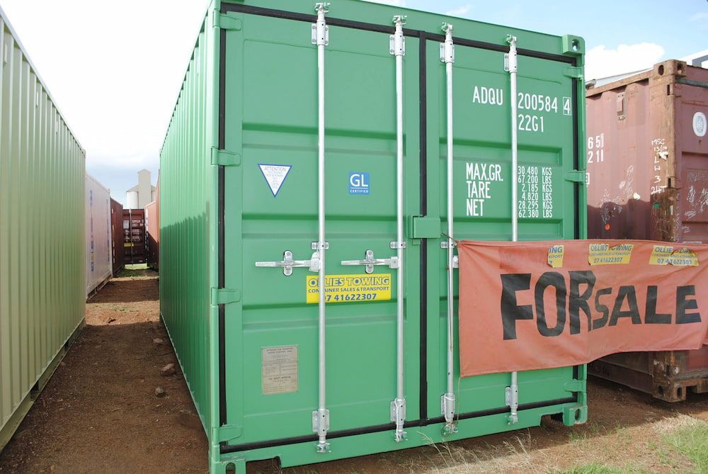 A Green Shipping Container With A For Sale Sign On It — Ollies Towing & Shipping Container Sales in Kingaroy, QLD