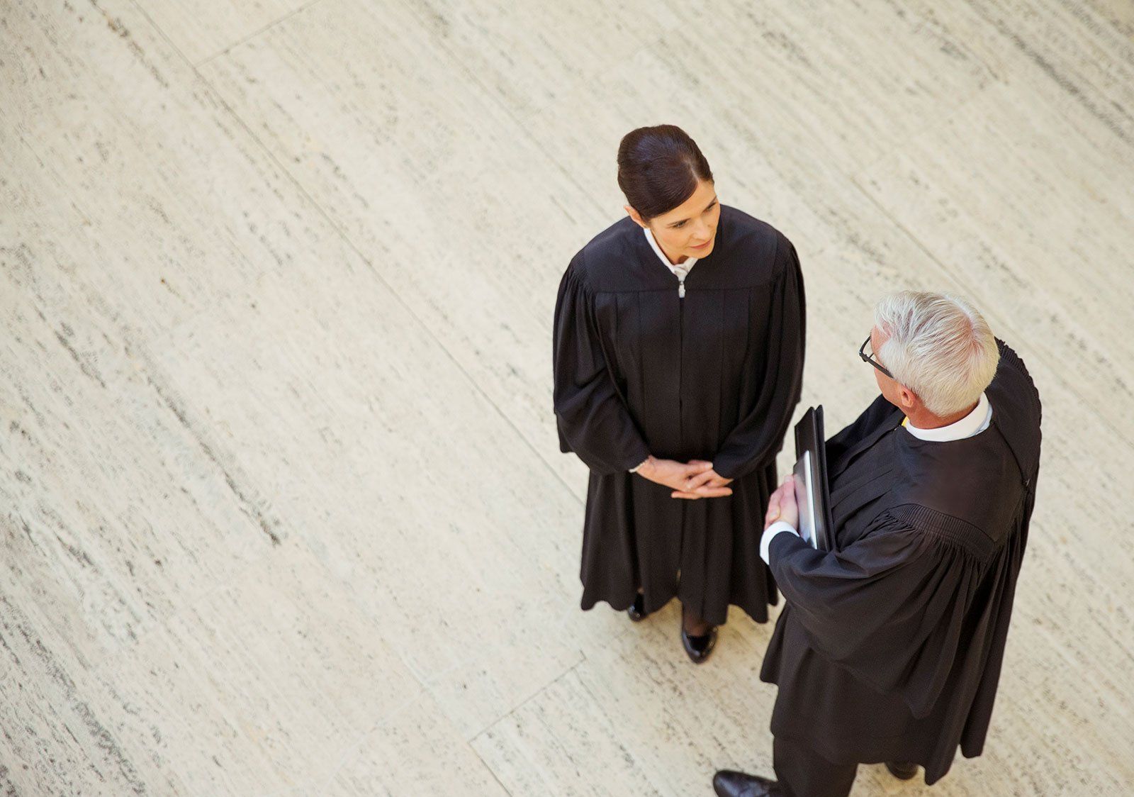 two lawyers in black robes talking