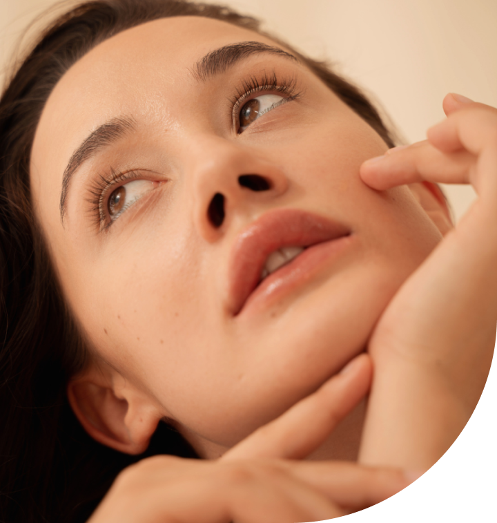 A close up of a woman 's face with her hand on her chin at ERA Wellness Spa in Georgetown, KY