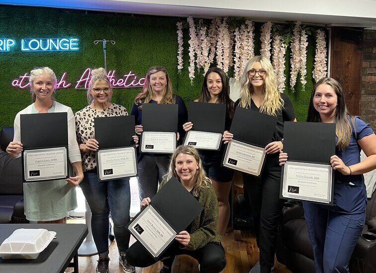a group of women holding certificates in front of a sign that says rip lounge at ERA Wellness Spa