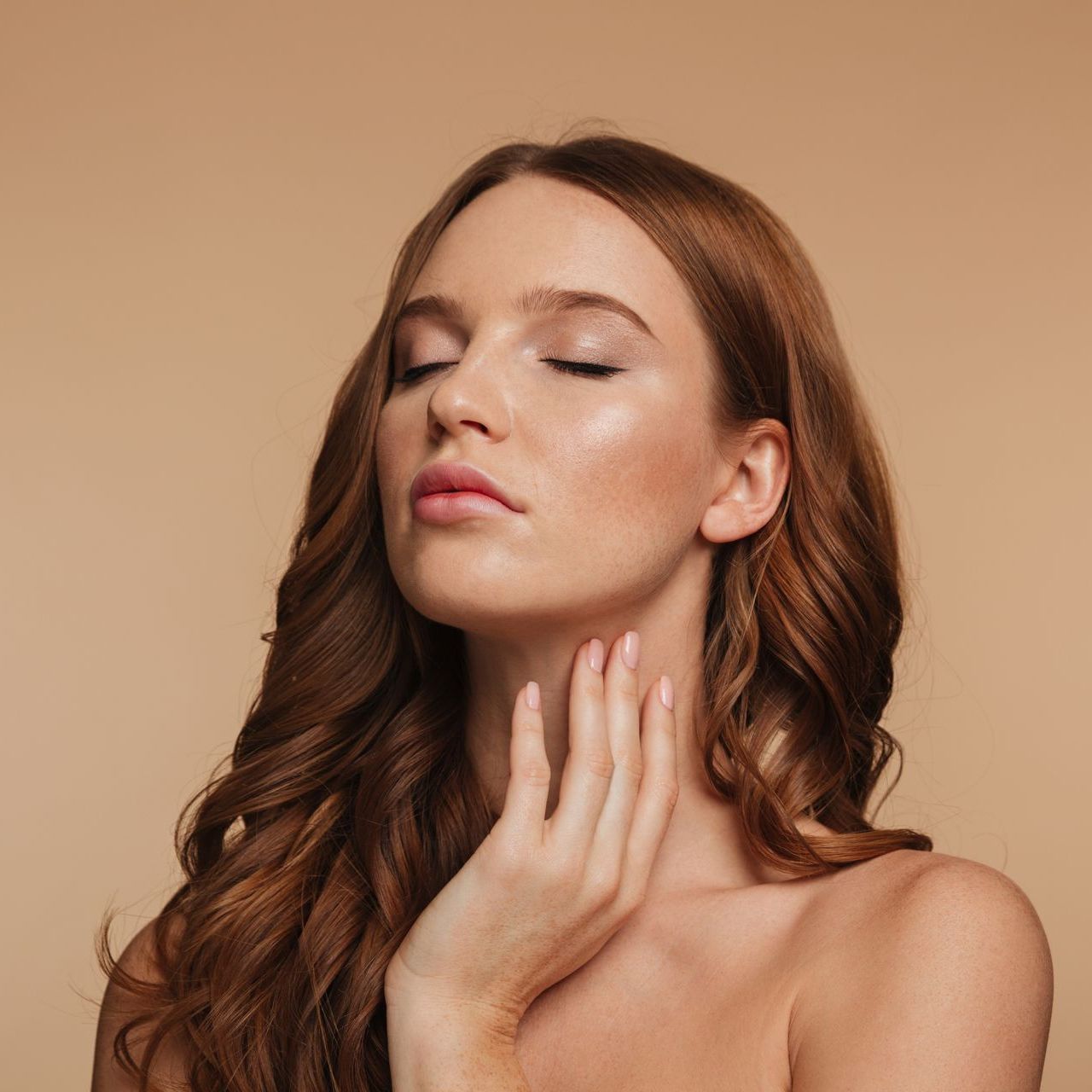 a woman with her eyes closed touches her neck with her hand at ERA Wellness Spa