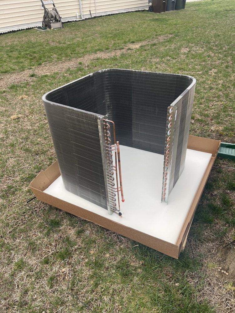 A large piece of metal is sitting on top of a cardboard box.
