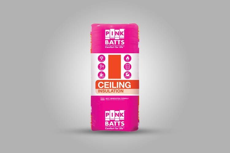 A pink bag of ceiling insulation is sitting on a gray surface.