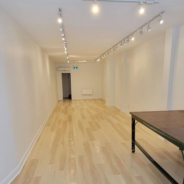 Une pièce vide avec du parquet et une table