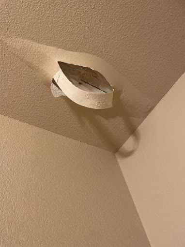 A piece of paper is hanging from the ceiling of a room.