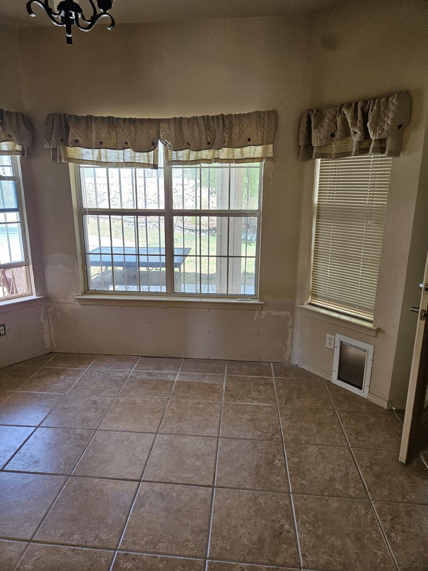 There is a dog door in the corner of the room.