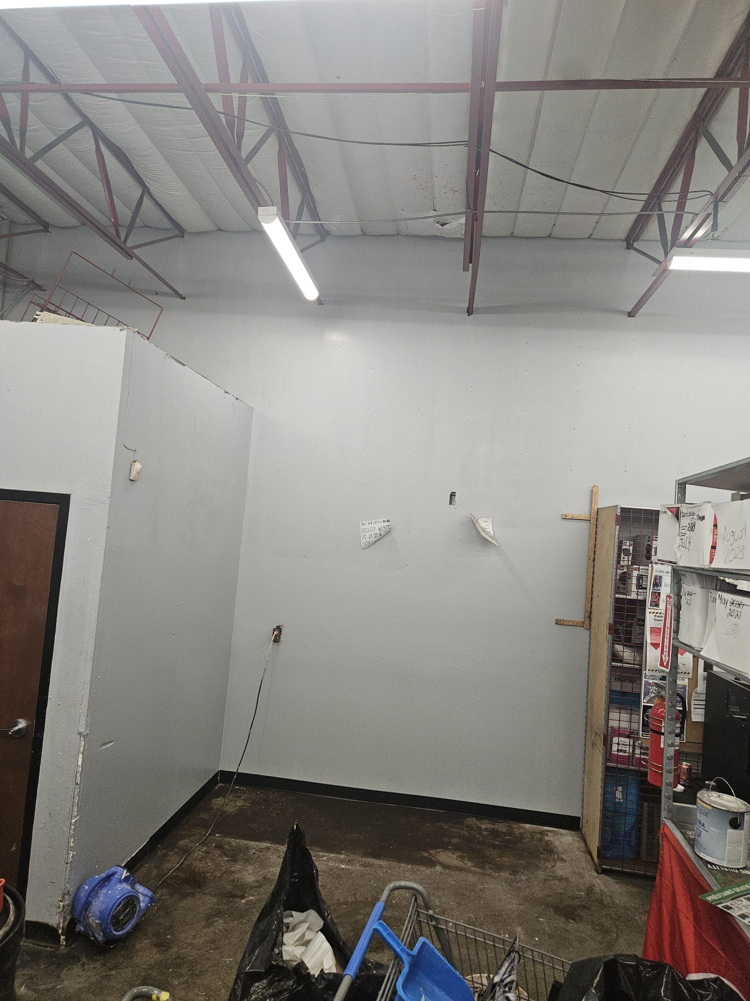 A room with white walls and a ceiling in a garage.