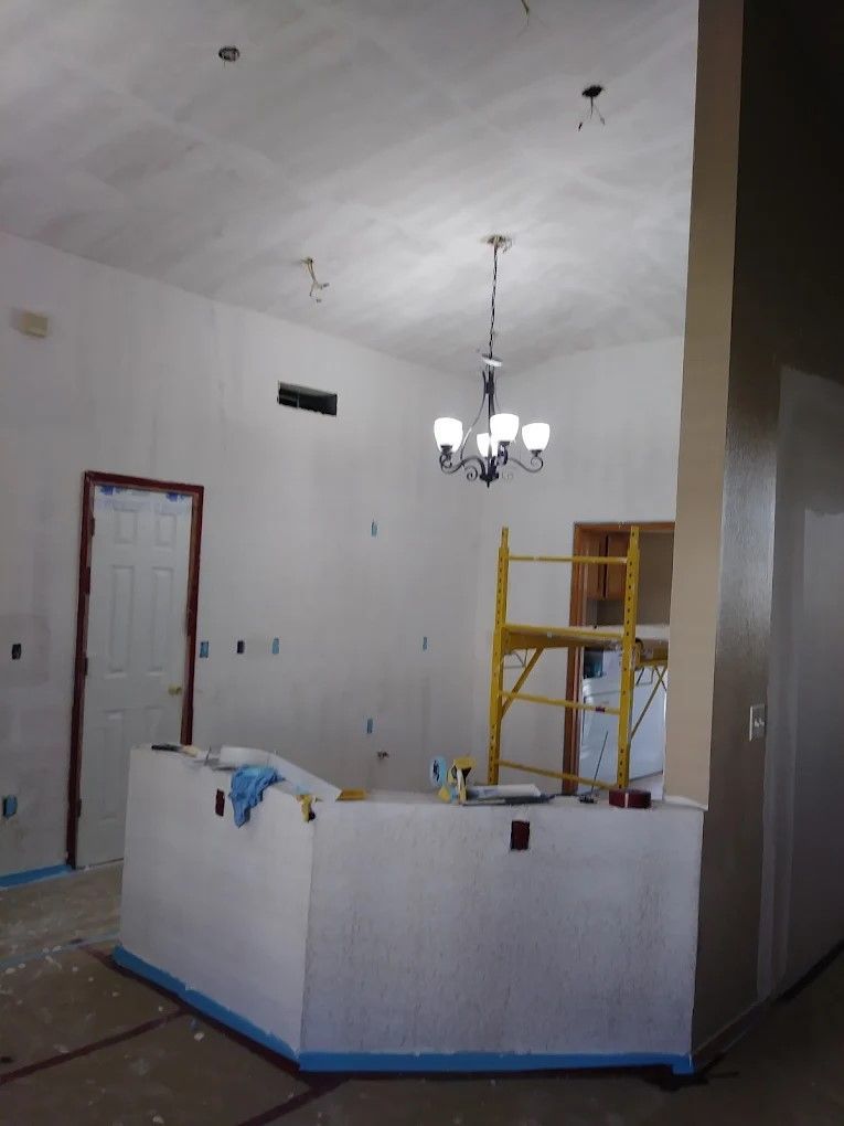 A room is being remodeled with drywall and a ladder.