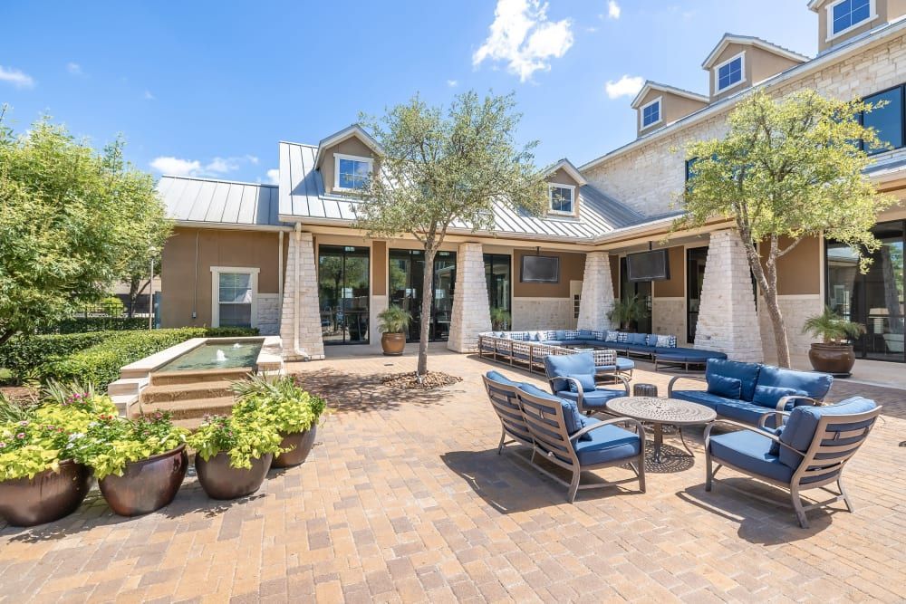 Resident outdoor lounge with a lot of furniture at Marquis at The Woodlands in Spring, TX.