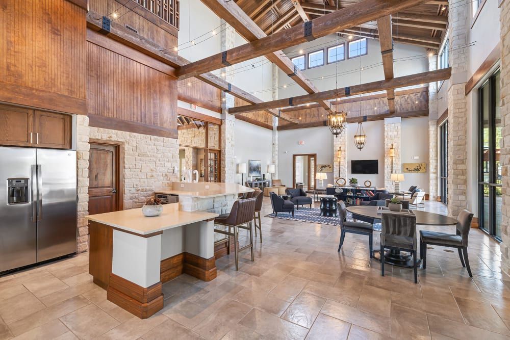 Clubhouse with a kitchen and dining areas at Marquis at The Woodlands in Spring, TX.