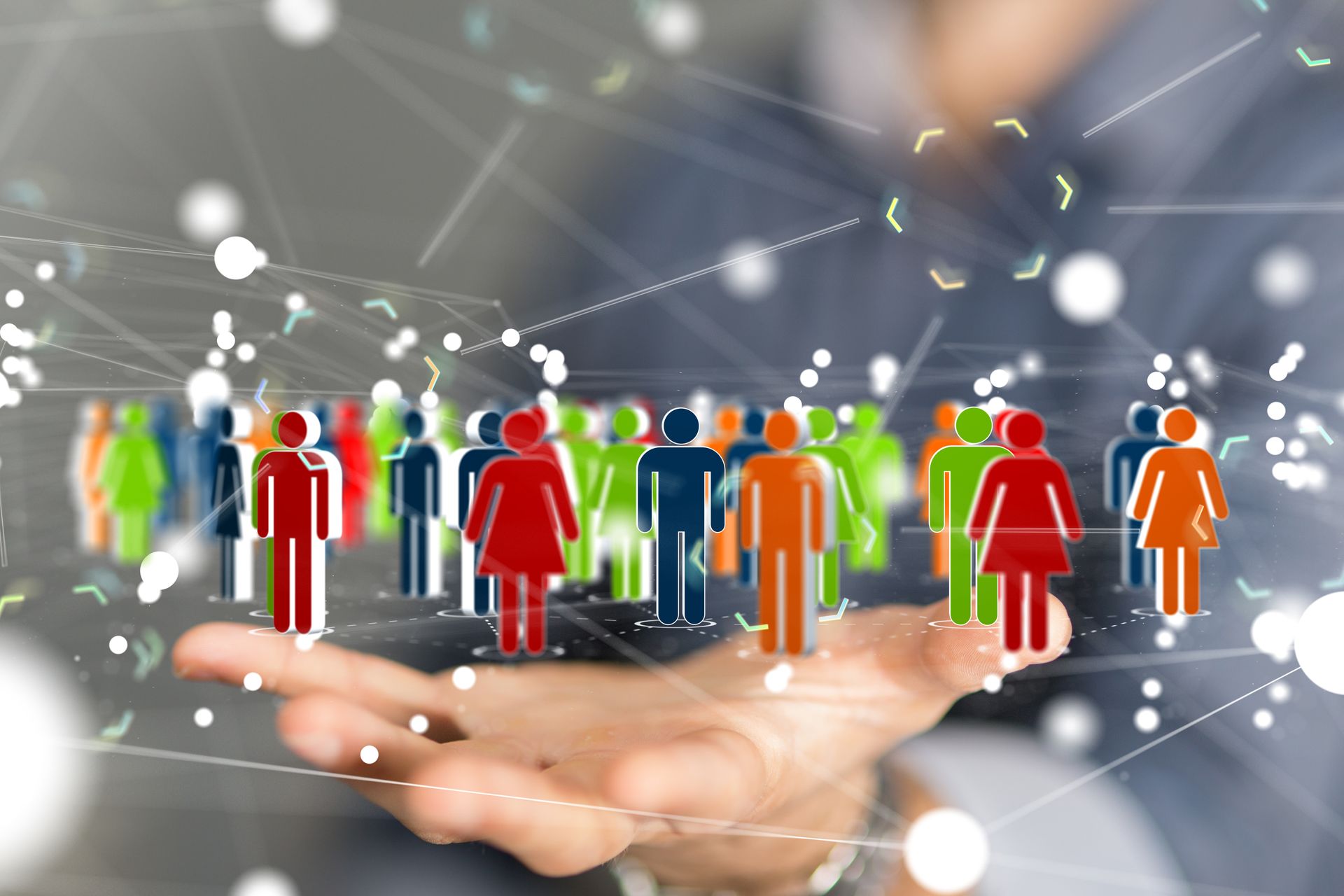Person holding a network of colourful people icons, representing diversity,and community.