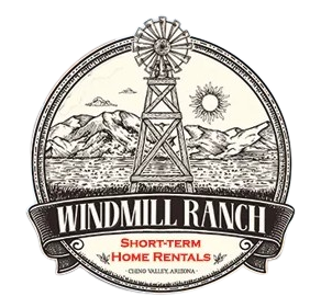 Windmill Ranch logo: A windmill over a landscape with mountains and sun, text 