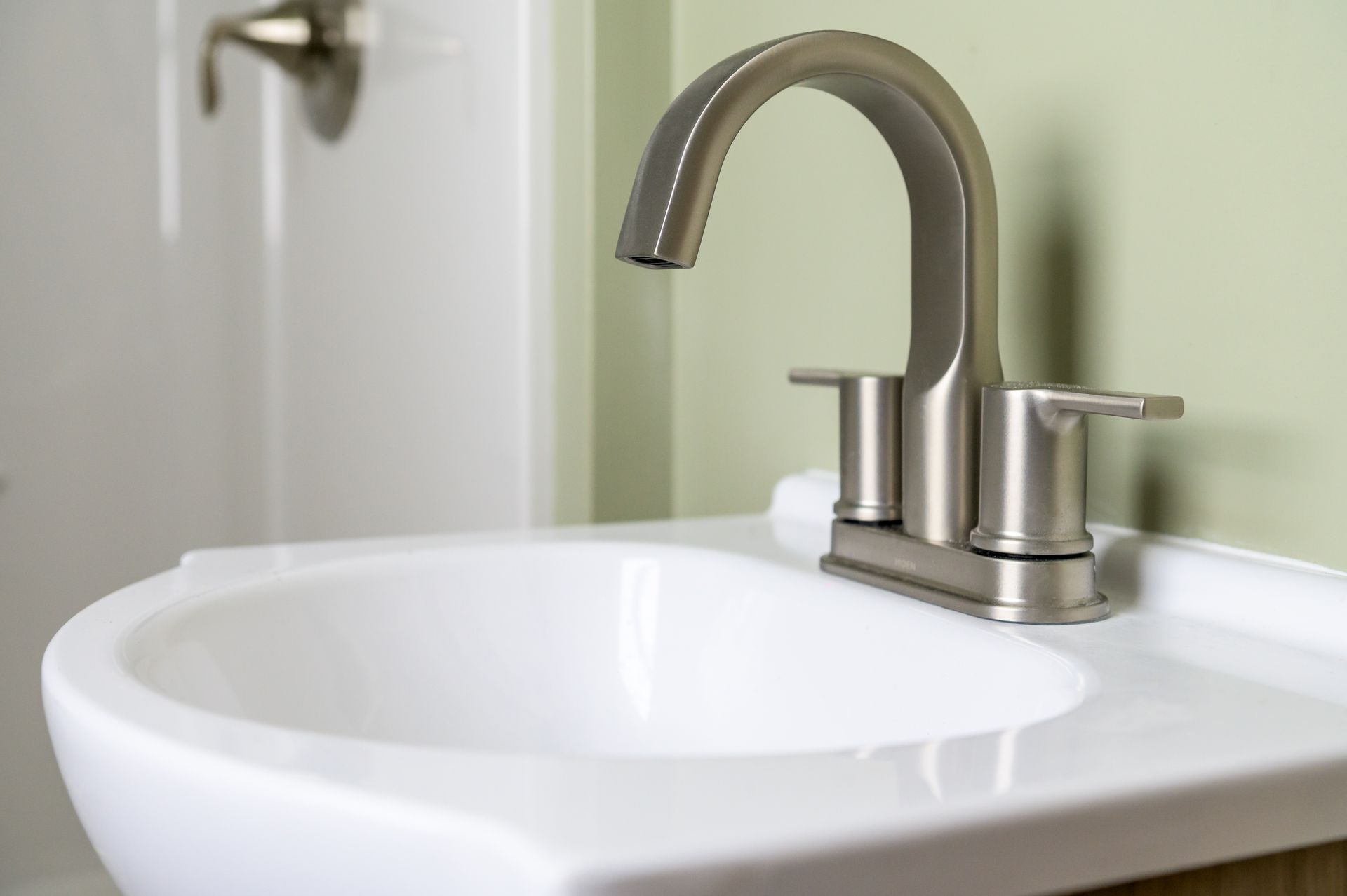 A bathroom sink with a stainless steel faucet