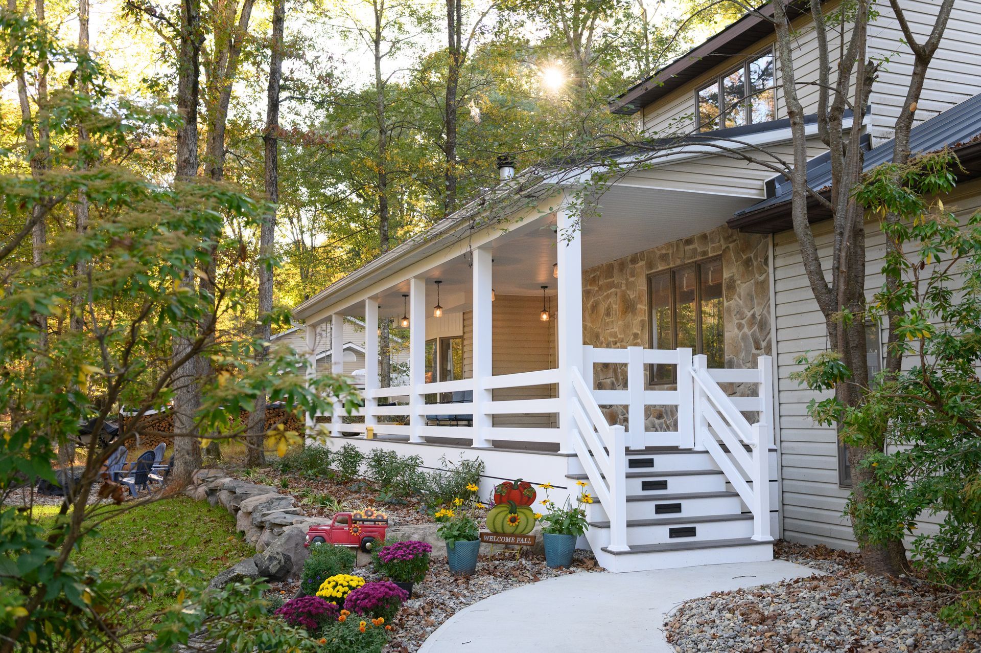 A large porch with rocking chairs and a ceiling fan.