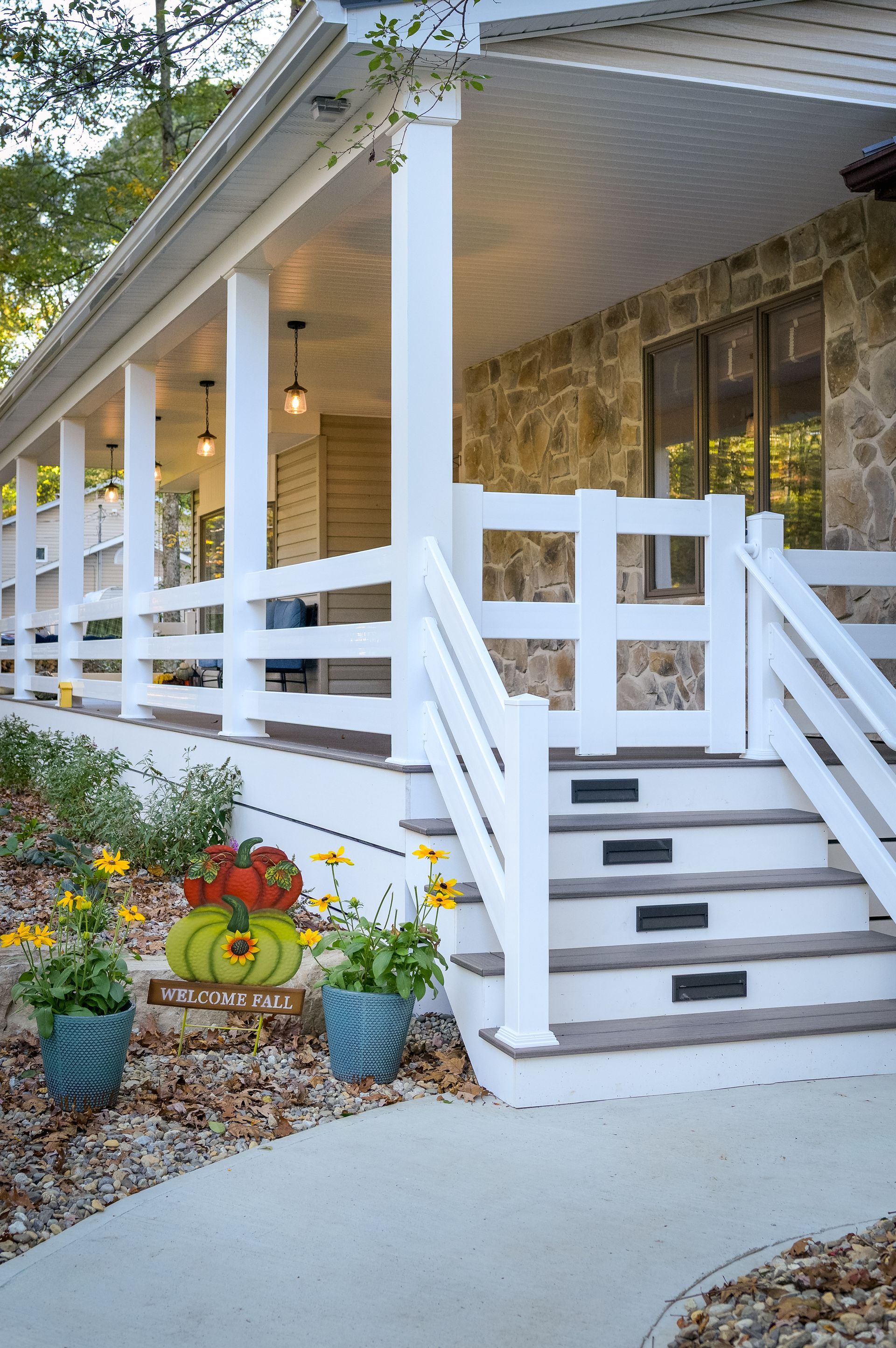 A long wooden porch with a railing and a window