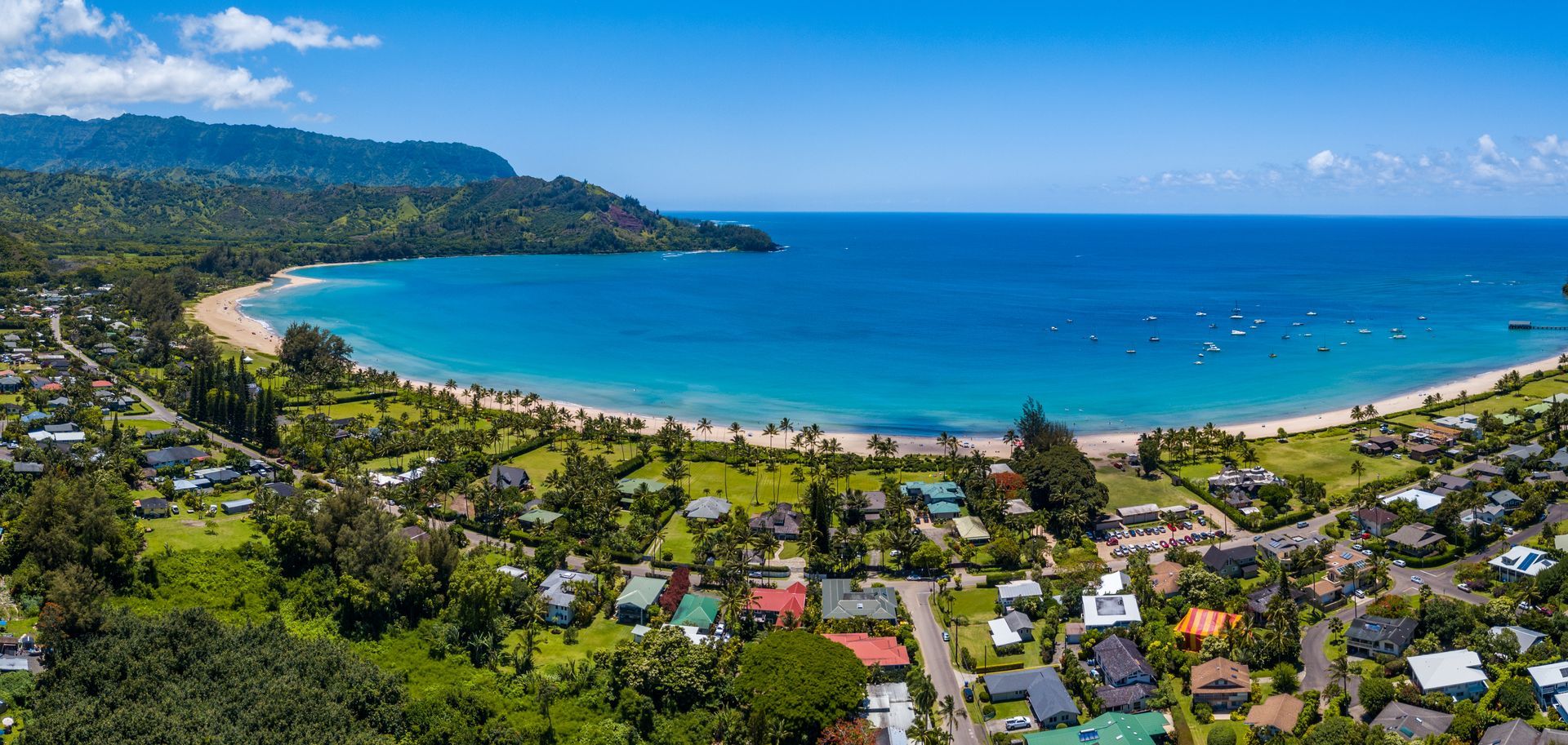 An aerial view of a small town next to a large body of water.