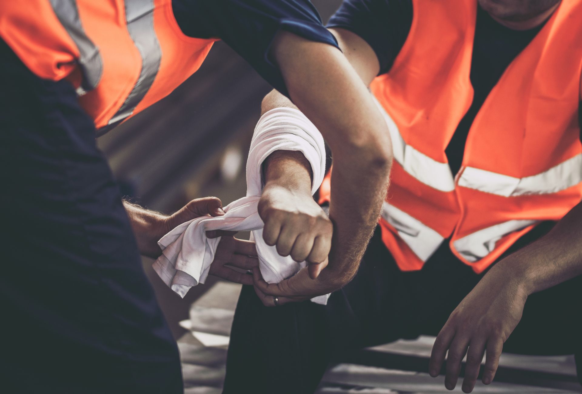 A man is getting a bandage on his wrist.