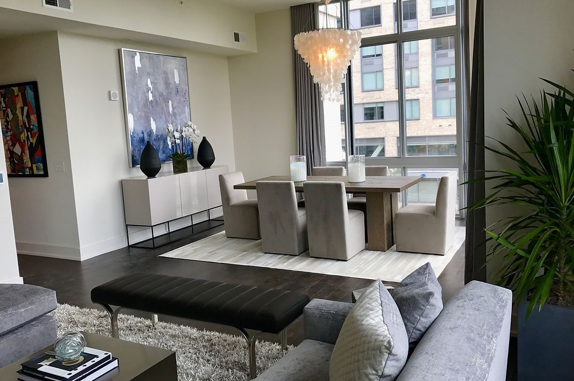 A living room with a couch , table and chairs