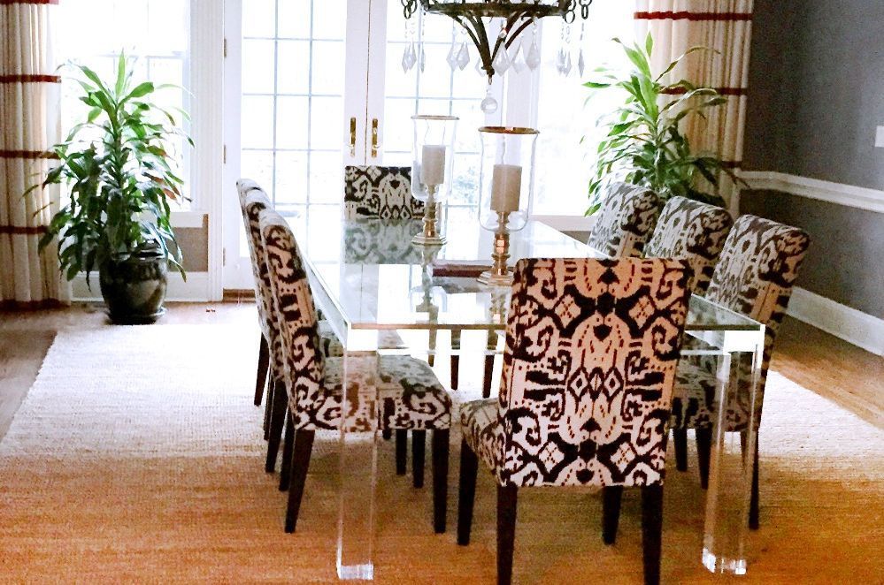 A dining room with a glass table and chairs