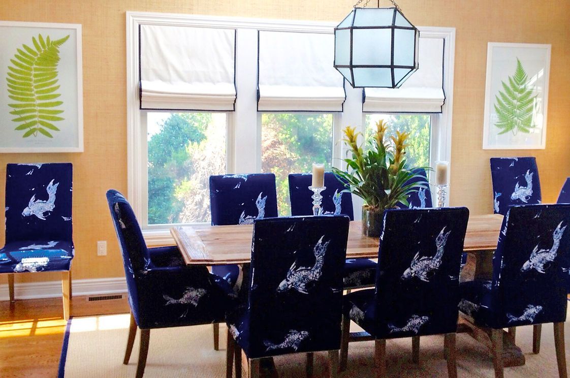 A dining room with blue chairs and a table