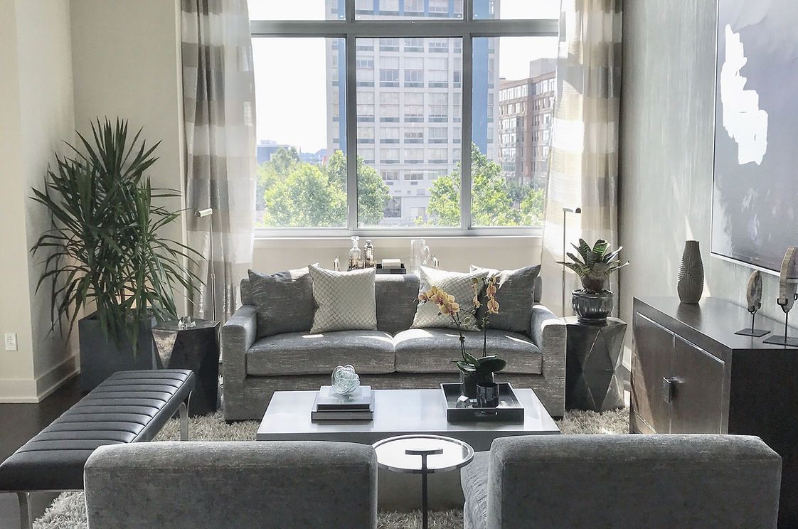 A living room filled with furniture and a large window.
