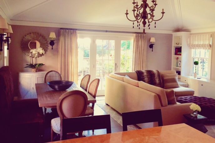 A living room with a table and chairs and a chandelier