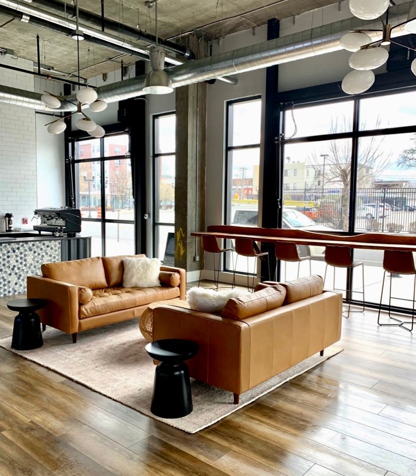 A living room with two couches , a table and chairs.