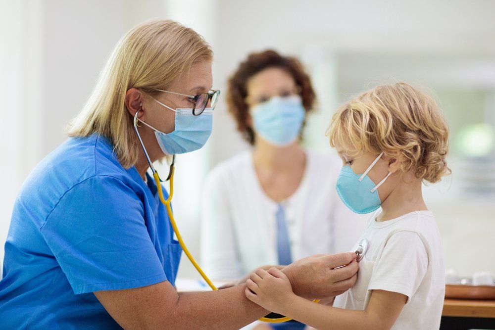 Doctor Examining Sick Child With Face Mask — Toms River, NJ — Sunny Pediatrics, Inc.