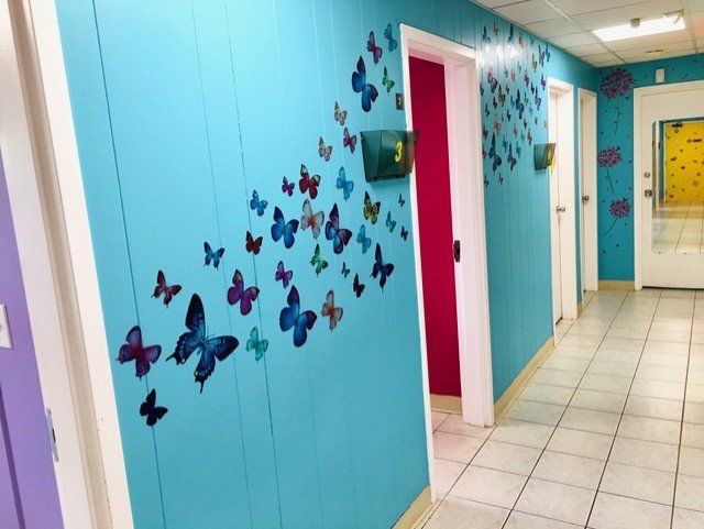 Hallway Butterfly Sticker On Wall — Toms River, NJ — Sunny Pediatrics, Inc.