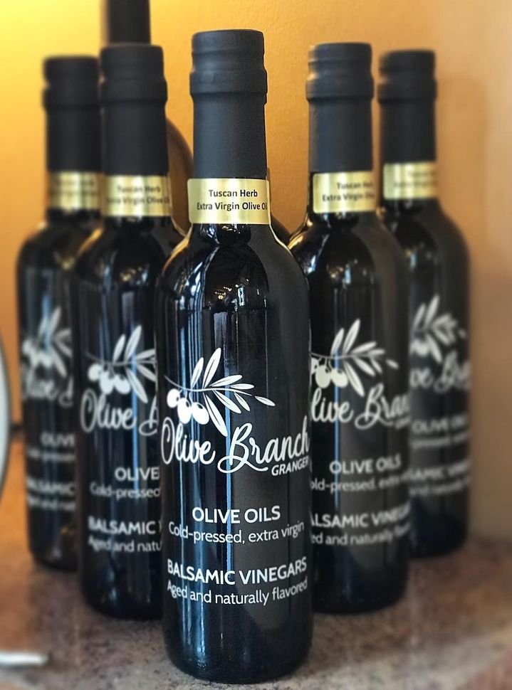 A group of bottles of olive oil and balsamic vinegar