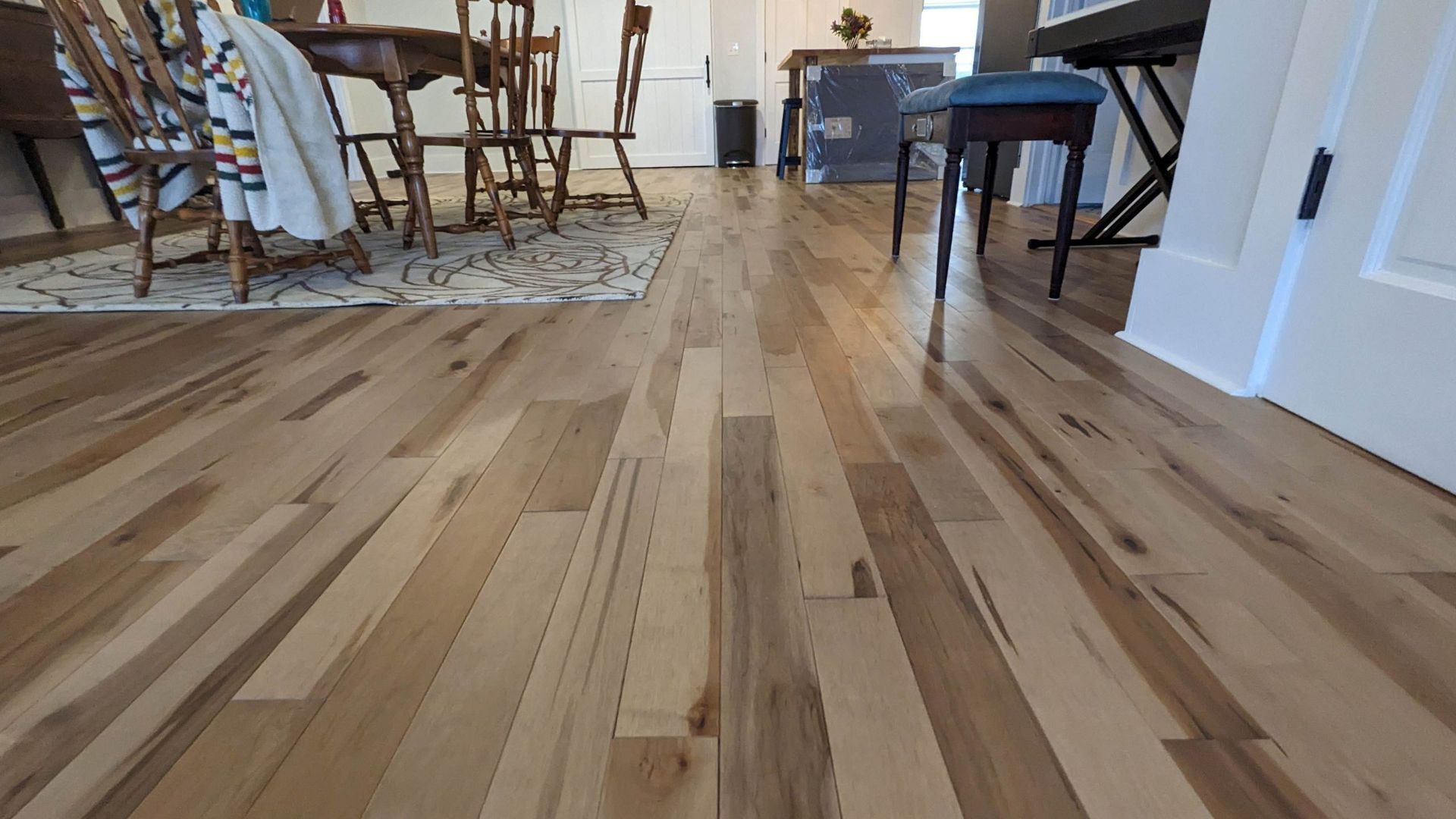 A beautiful wood floor is installed by Juggernaut Construction Company in a kitchen and dining room during a remodel in Vermont