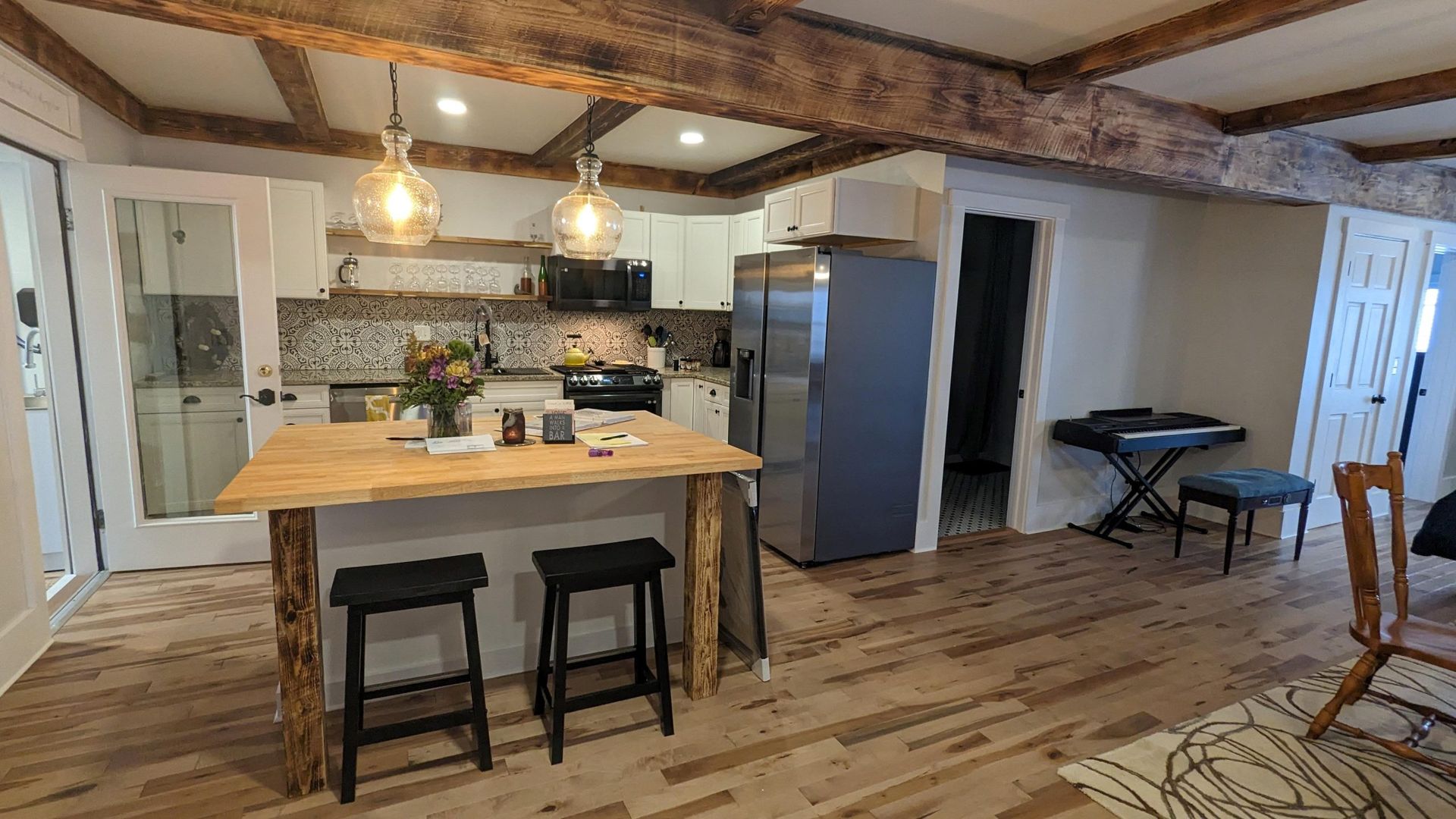 Vermont kitchen remodel with wood floors, butcherblock counters, and clean, white cabinets