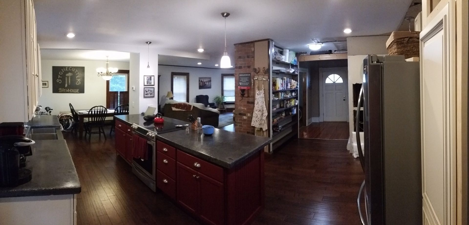 A Vermont kitchen and dining room remodel with black granite counters, cherry cabinets, and cherry floors done by Juggernaut