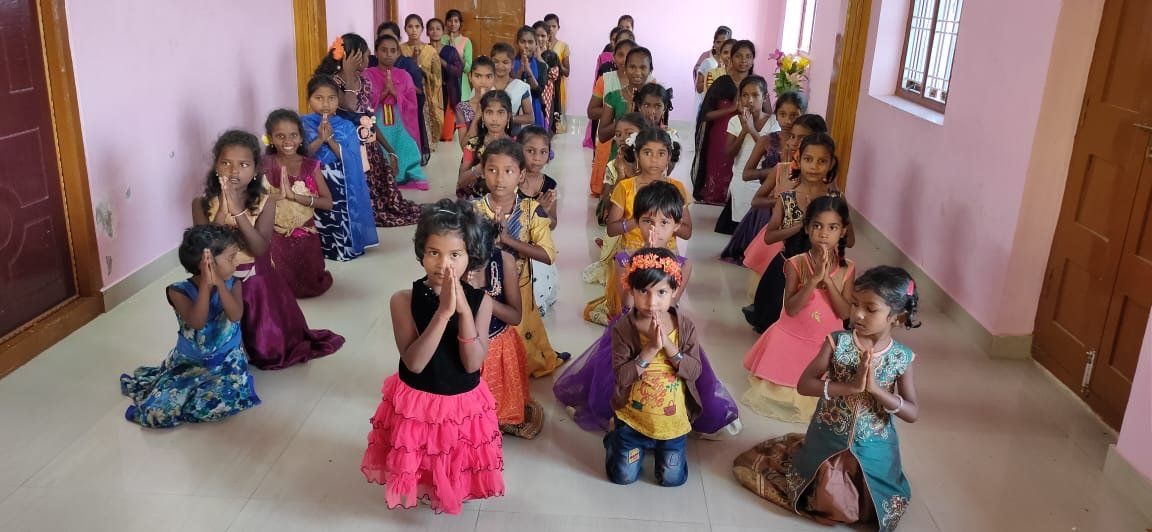A group of children are dancing in a room.