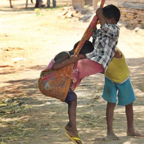 A boy is carrying a girl on his back