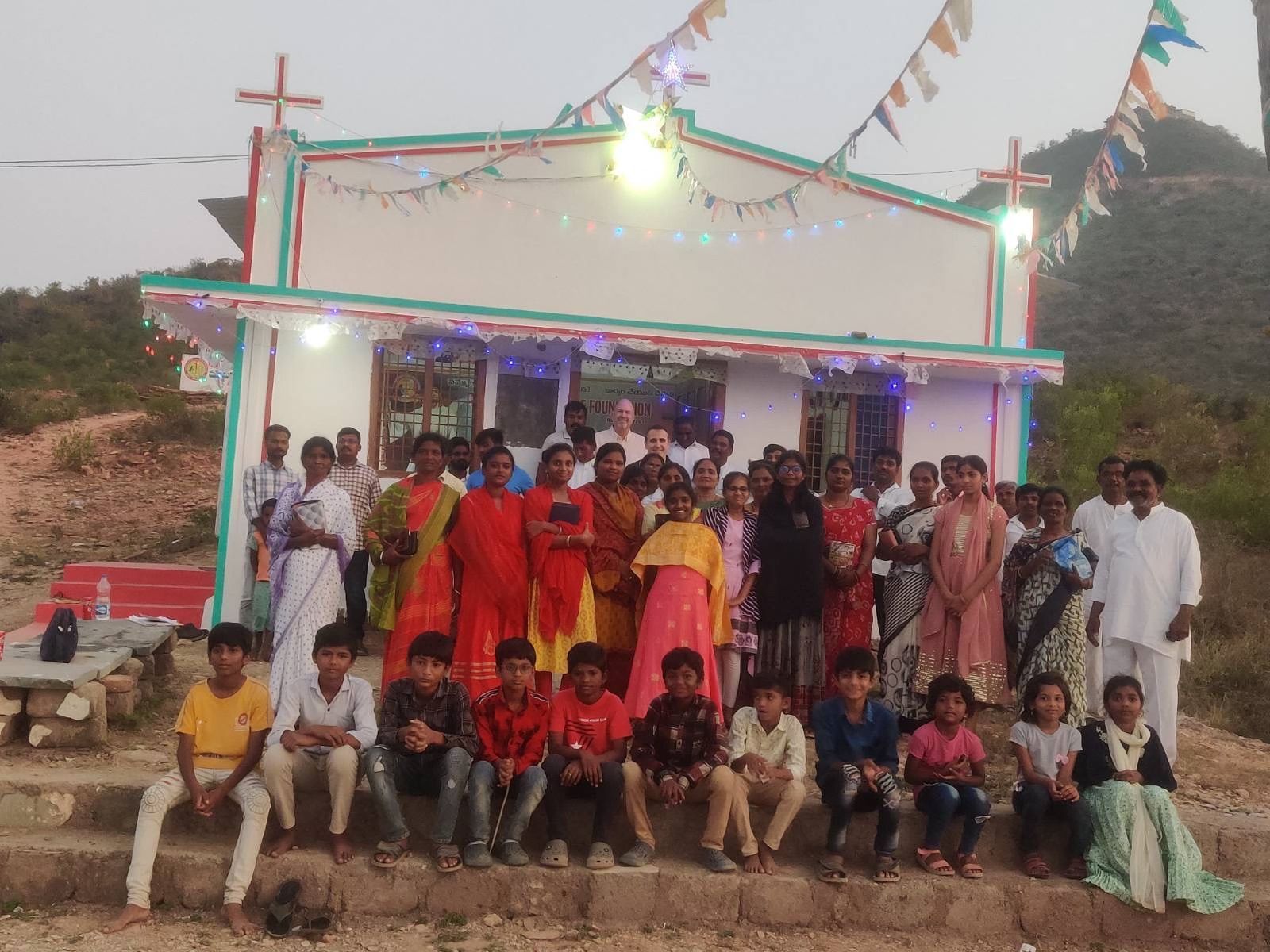 A group of people are posing for a picture in front of a church.