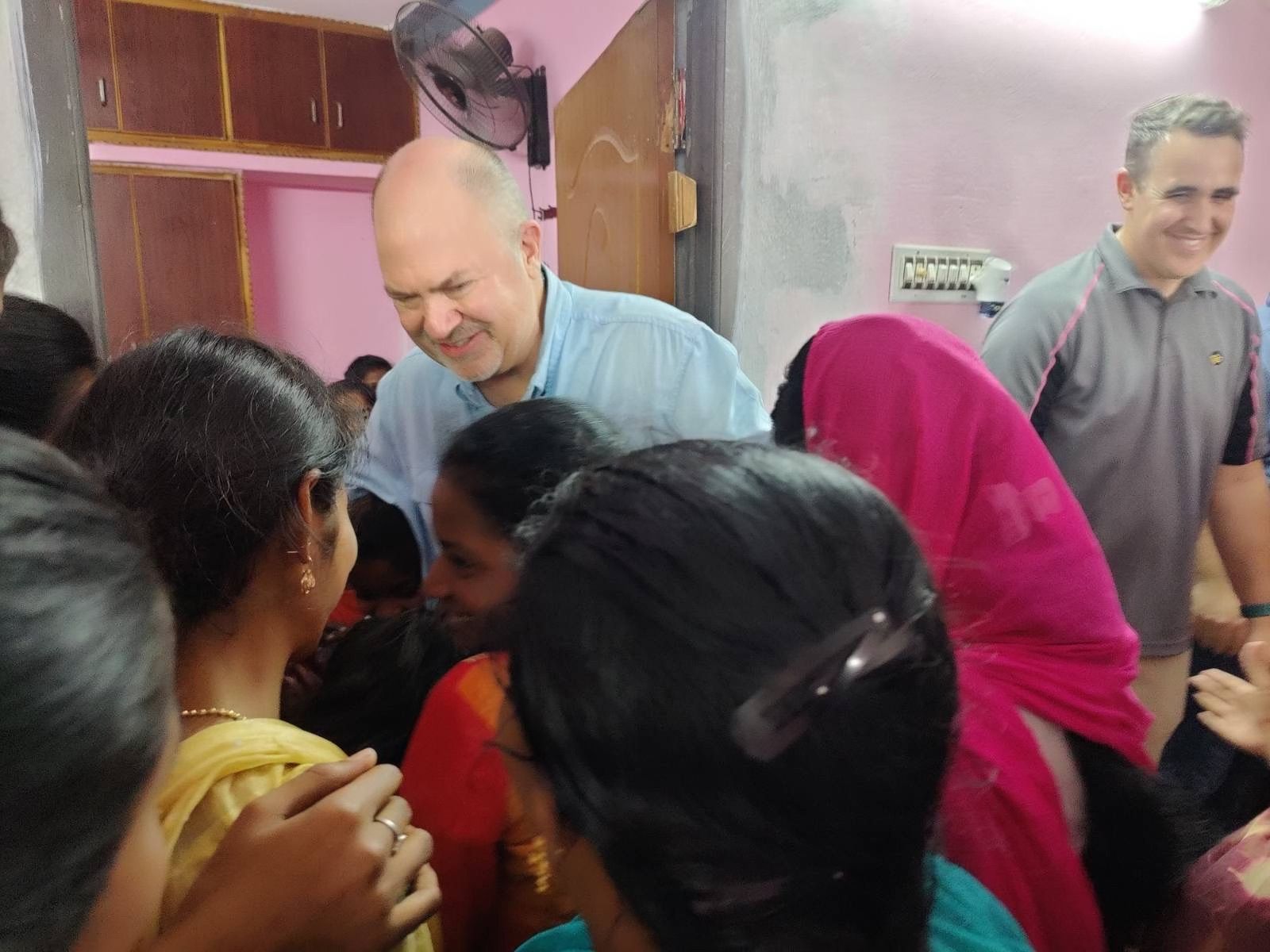 A man is talking to a group of people in a room