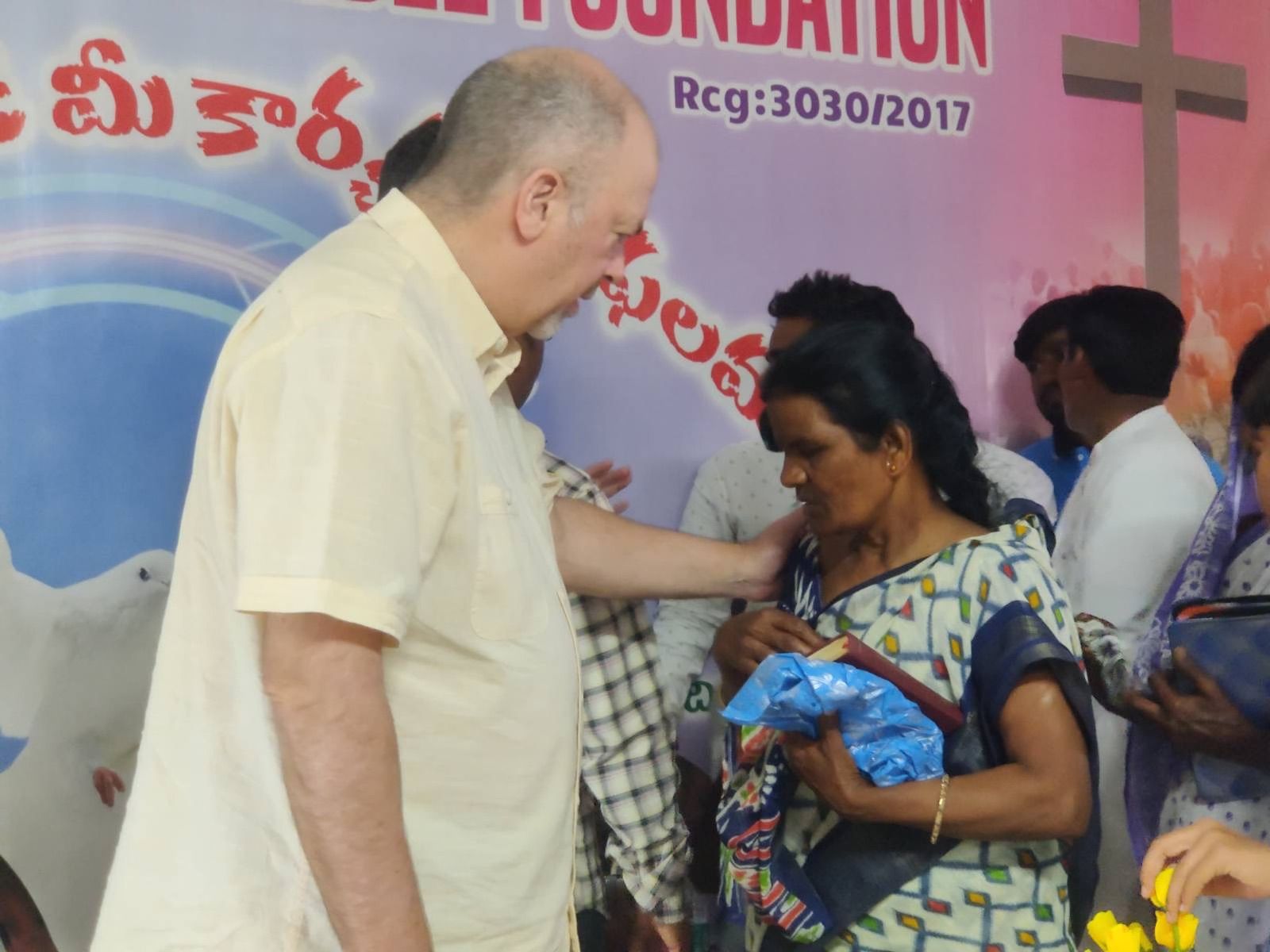 A group of people are standing in front of a sign that says foundation