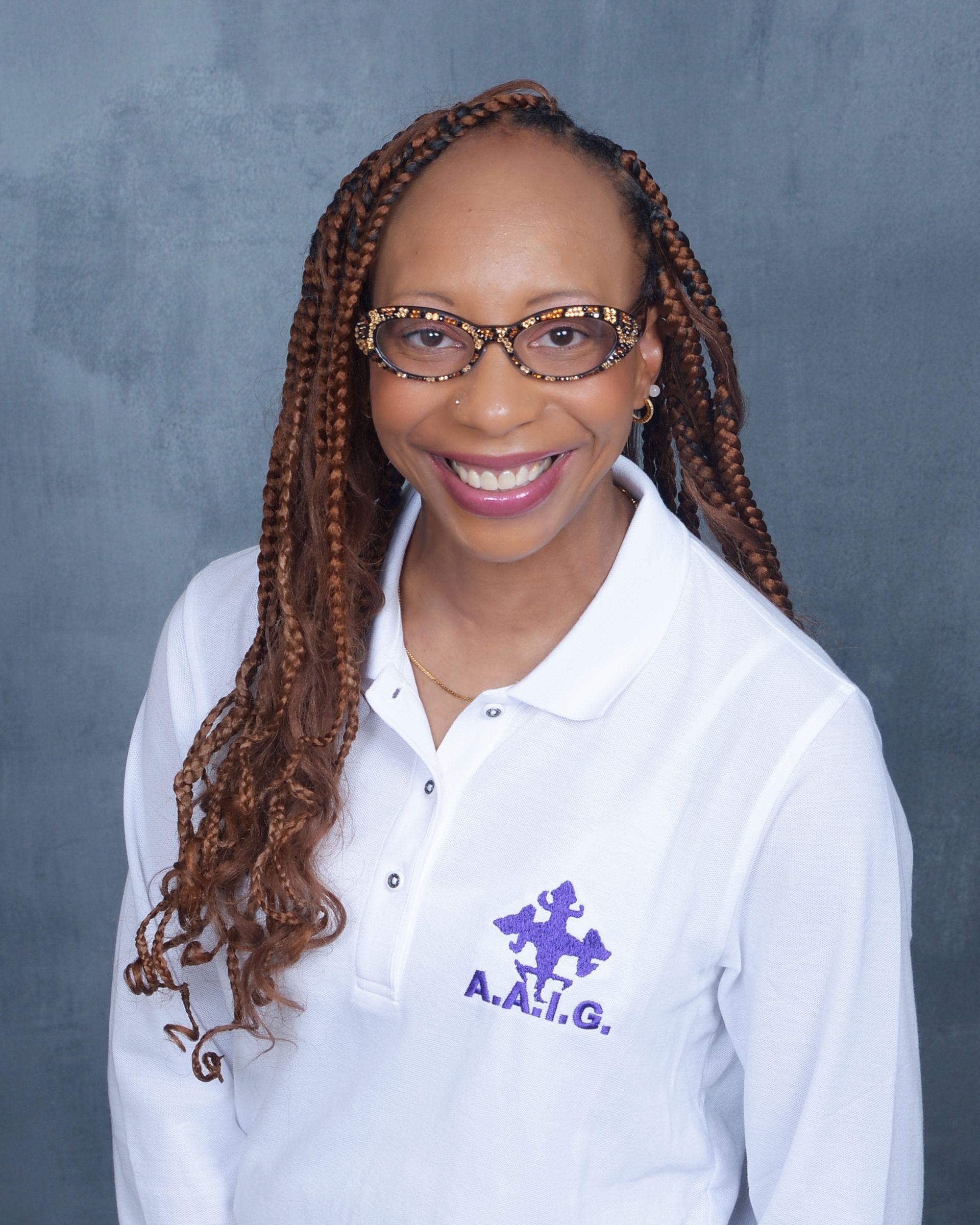 Aisha C. Young Aisha C. Young wearing a white shirt with a purple A.A.I.G. logo.