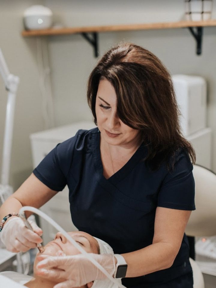 Lela completing a skincare service on a client in Evergreen, Colorado at Lela Skin Care and Facials